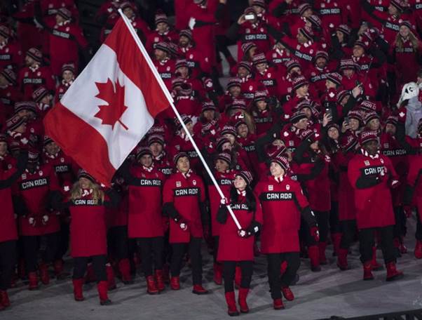 Canadian ice dance team Tessa Virtue and Scott Moir lead Team Canada into the Olympic stadium as the flag bearers.